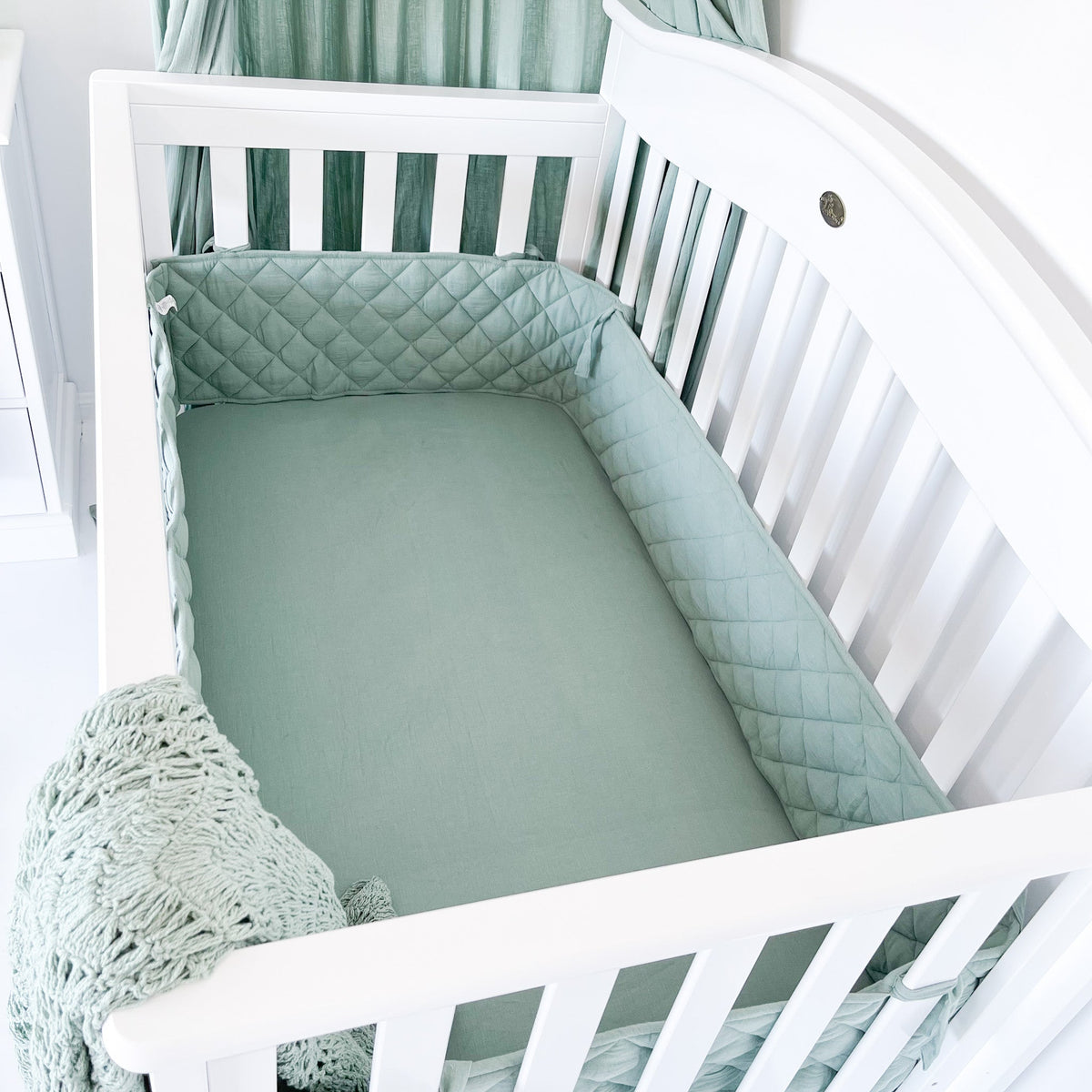 Inside of Heritage cot with mattress base lowered
