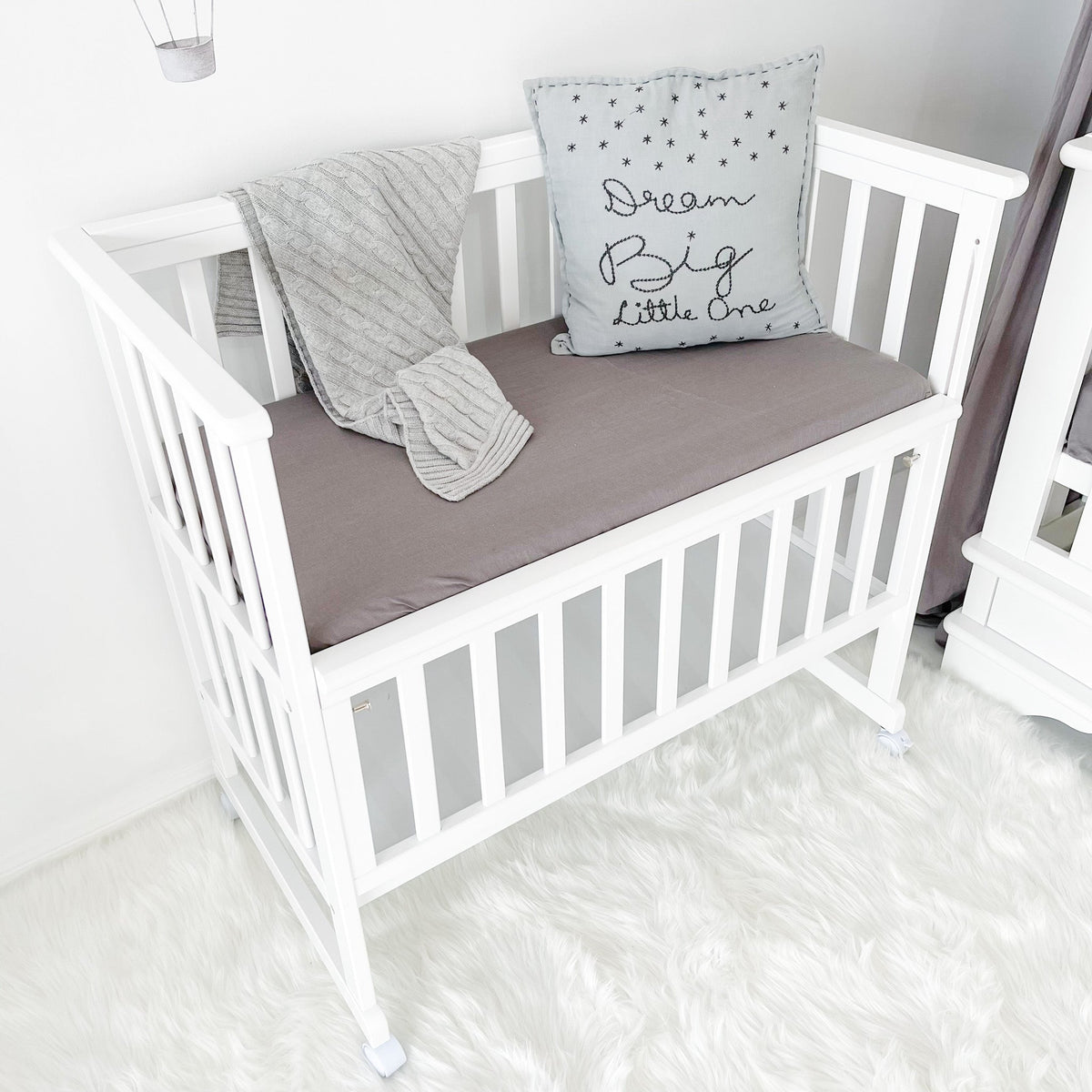 Bedside bassinet with front rail lowered
