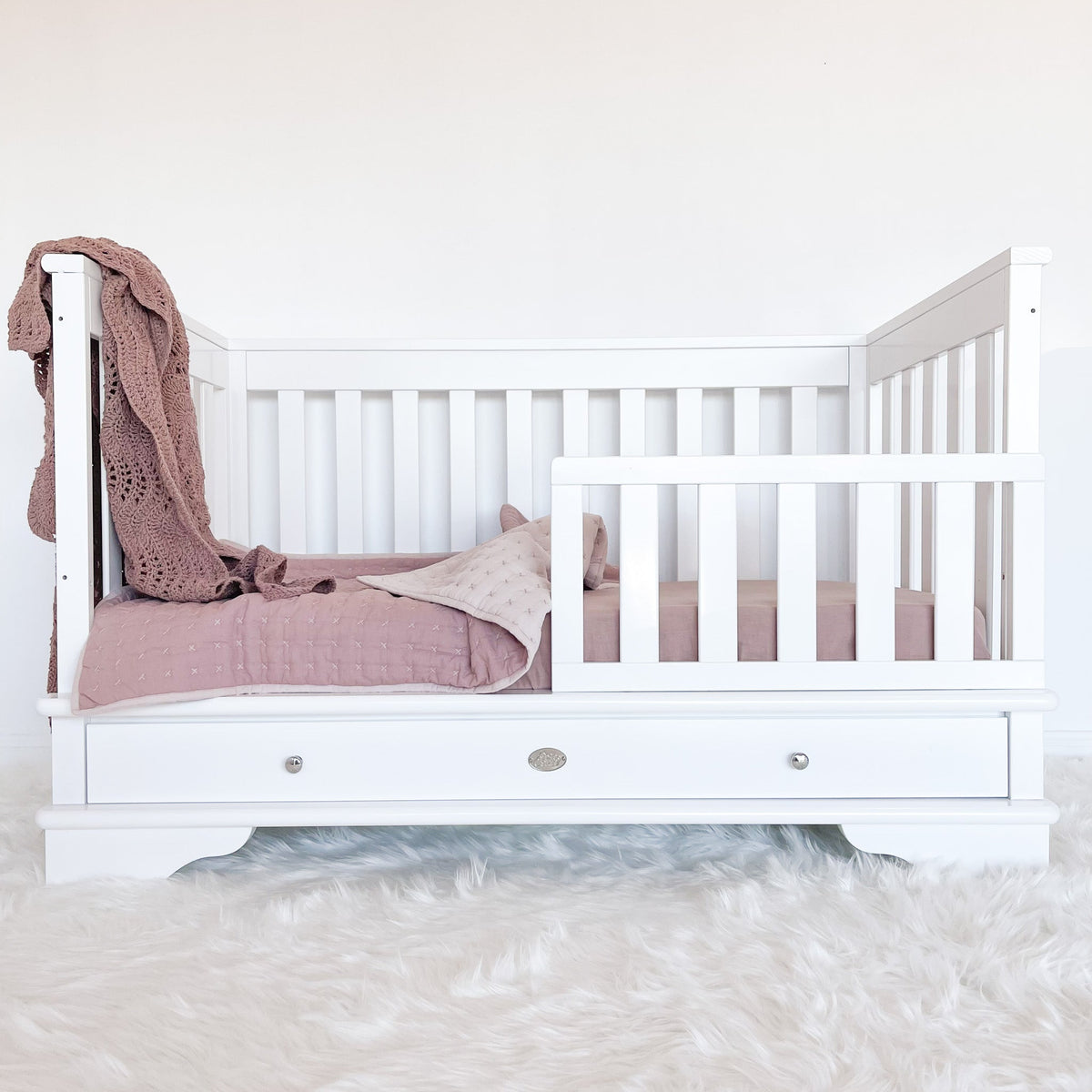 Contemporary cot with toddler rail attached