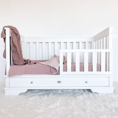 Contemporary cot with toddler rail attached